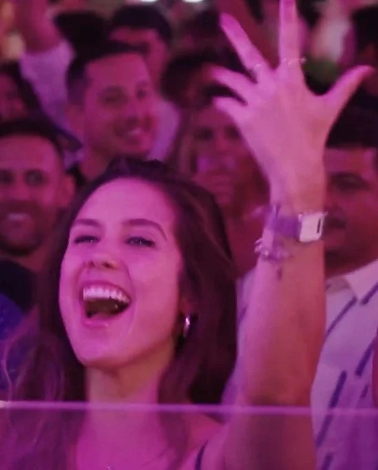 Crowd dancing under magenta light